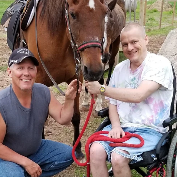 Man in wheelchair and director next to horse
